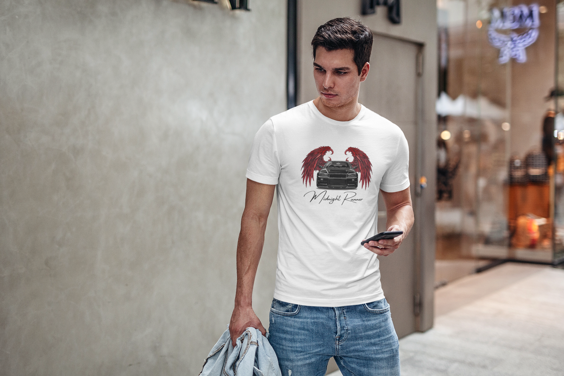 young man standing near a store wearing a jdm shirt